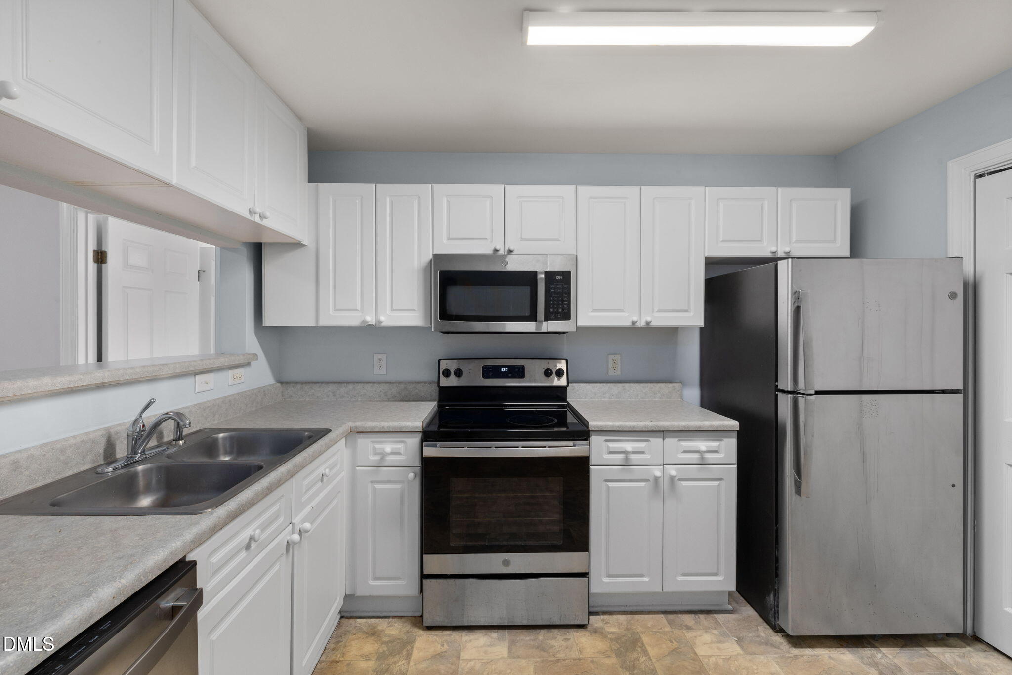 929 Morreene Road, Unit C23 Durham, NC 27705 - Photo 9 of 33 a kitchen with a stove microwave and refrigerator