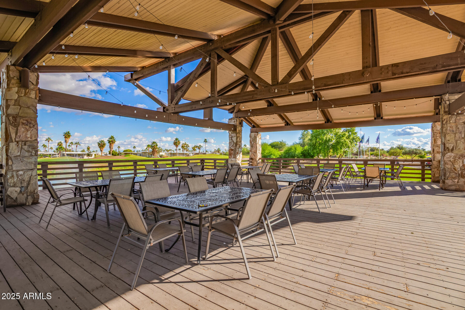 17200 West Bell Road, Unit 966 Surprise, AZ 85374 - Photo 17 of 21 a view of a swimming pool with a table and chairs