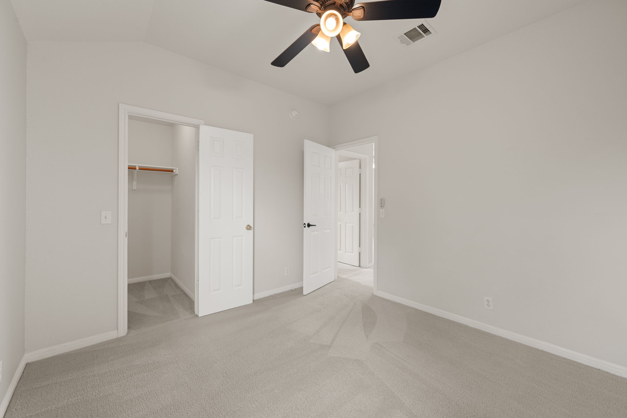 8902 Magna Carta Loop, Unit 122 Austin, TX 78754 - Photo 28 of 39 A spacious bedroom offers a neutral palette with soft carpeting and an overhead ceiling fan for comfort.