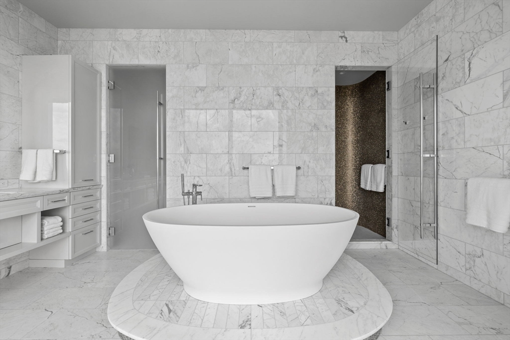 1 Dalton Street, Unit 5101 Boston, MA 02115 - Photo 15 of 31 a white bath tub sitting in a bathroom