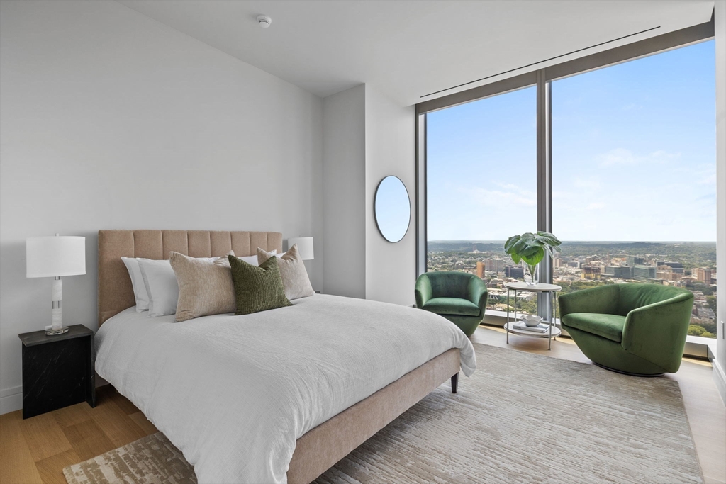 1 Dalton Street, Unit 5101 Boston, MA 02115 - Photo 17 of 31 a bedroom with a bed a couch and a large window