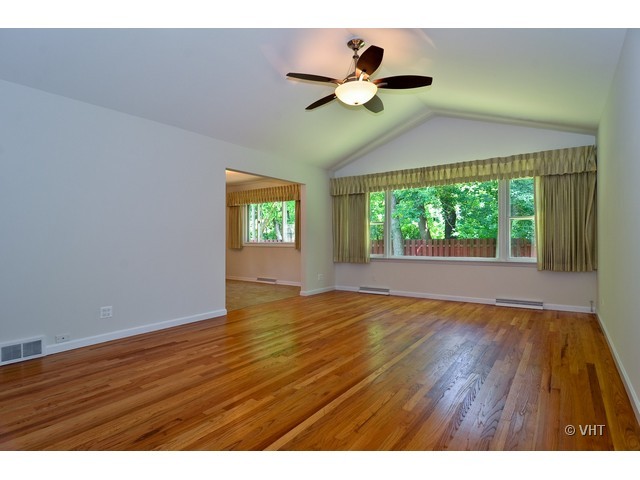 1205 Arbor Vitae Road Deerfield, IL 60015 - Photo 3 of 10 a view of an empty room with wooden floor and a window