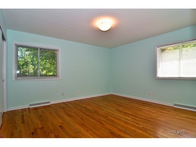 1205 Arbor Vitae Road Deerfield, IL 60015 - Photo 7 of 10 an empty room with wooden floor and windows