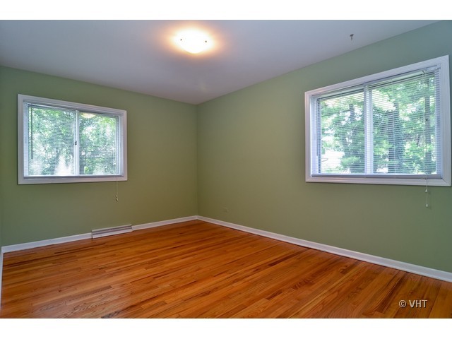 1205 Arbor Vitae Road Deerfield, IL 60015 - Photo 8 of 10 a view of an empty room with wooden floor and a window
