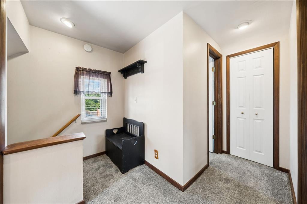 711 Jane Street Pittsburgh, PA 15239 - Photo 16 of 27 Top of the stairs landing area featuring neutral carpeting and a built-in storage unit.