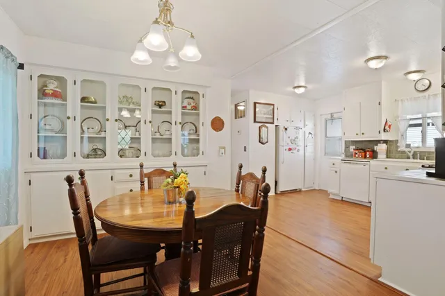 a view of a dining room with furniture and chandelier