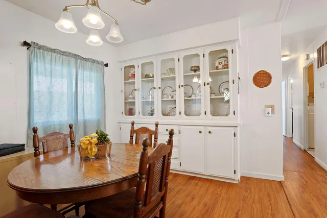 a view of a dining room with furniture and wooden floor