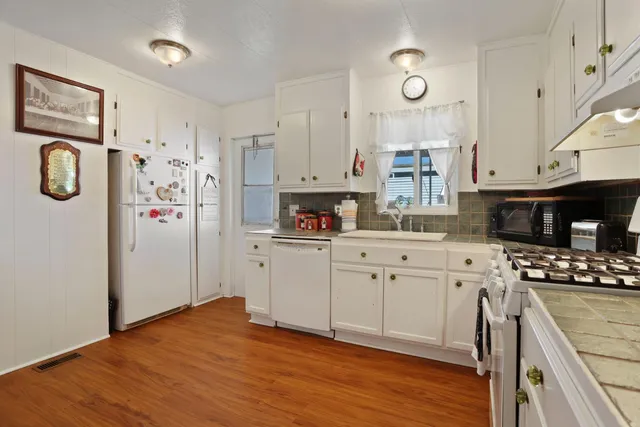 a kitchen with stainless steel appliances a refrigerator sink and cabinets