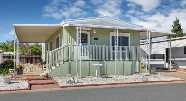 a backyard of a house with barbeque oven table and chairs