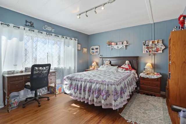 a bedroom with a bed and a table in it