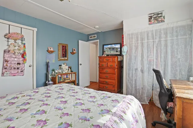 a bedroom with a bed and a dresser in it