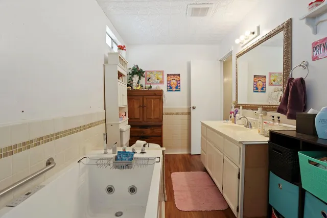 a bathroom with a sink a vanity and mirror
