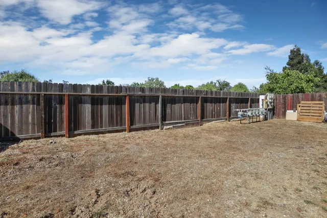 a view of street with wooden fence