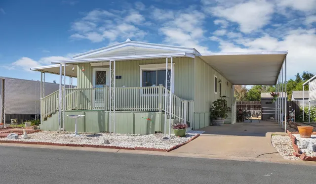 a front view of a house with a garden and patio