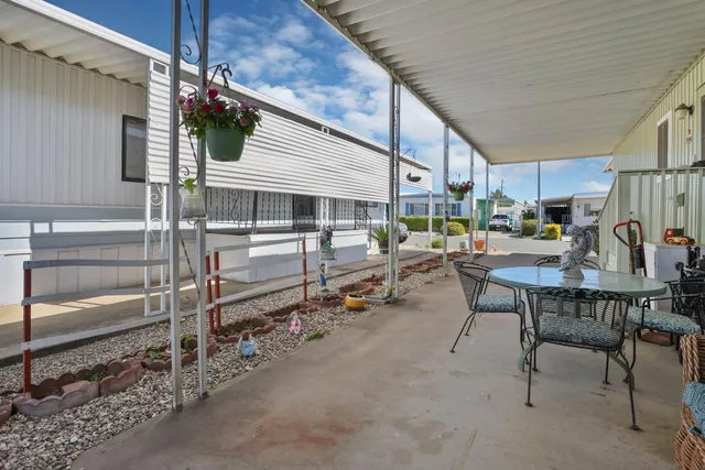 a view of a patio with table and chairs