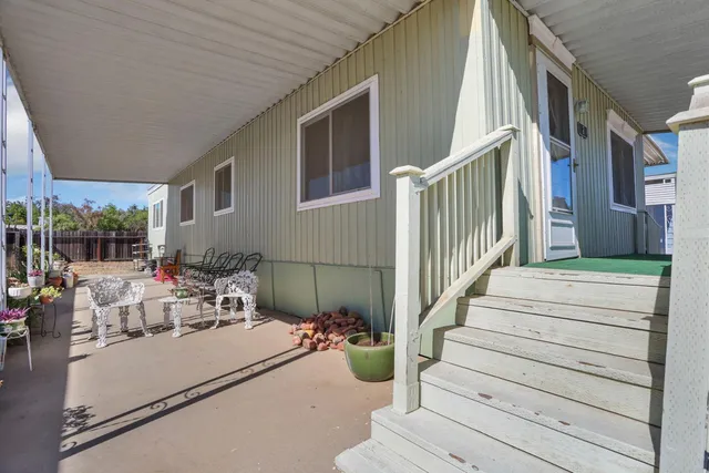 a view of a patio with couches and potted plants