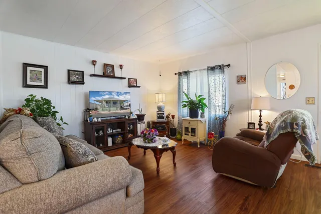 a living room with furniture fireplace and a large window