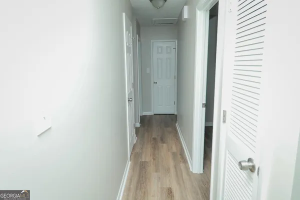 a view of a room with wooden floor