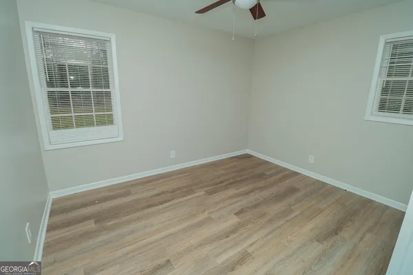 an empty room with wooden floor and closet