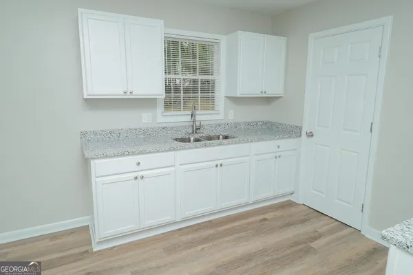 a view of a kitchen with granite countertop cabinets