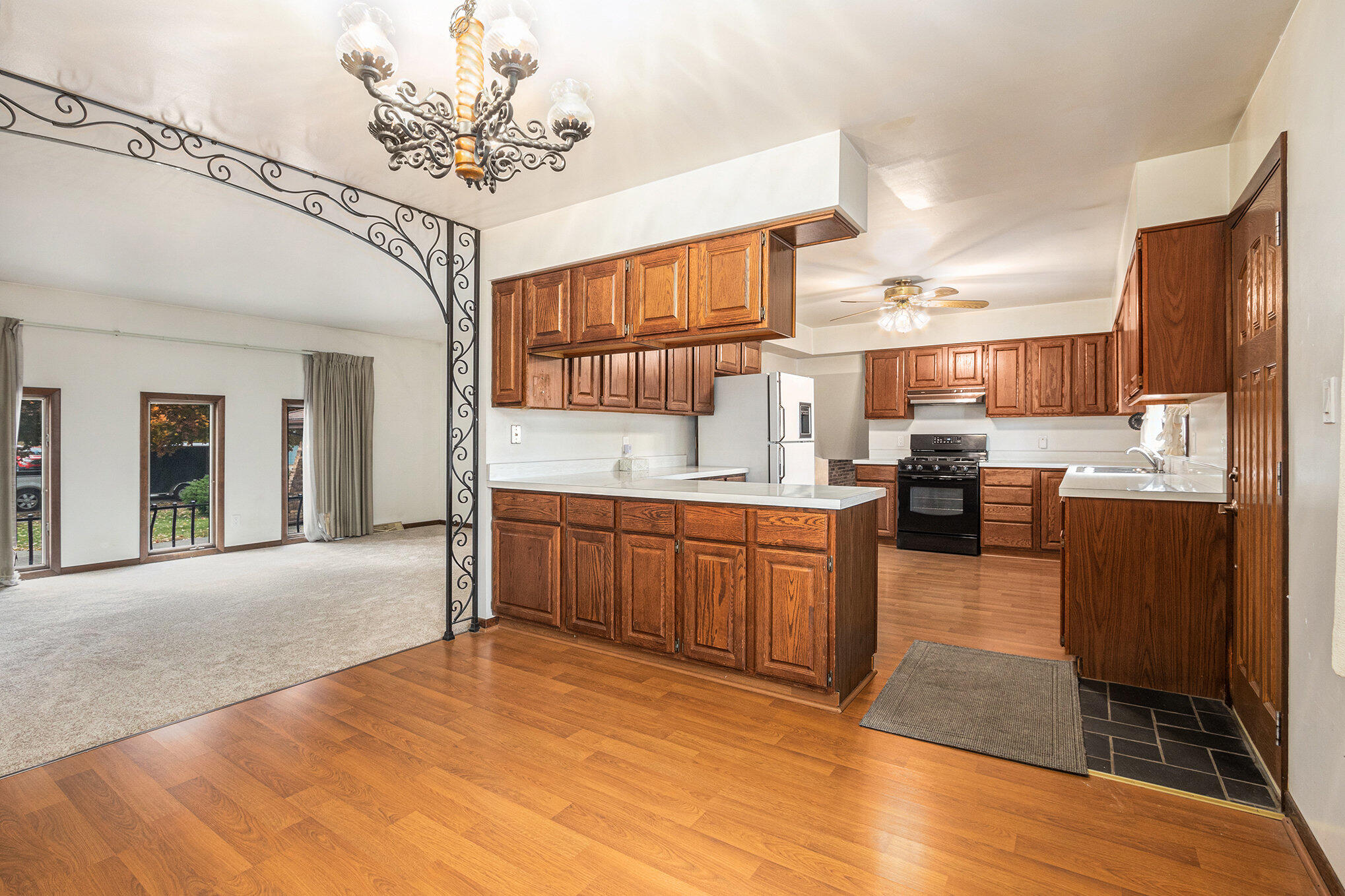 7905 Frederick Avenue Munster, IN 46321 - Photo 5 of 26 a large kitchen with kitchen island granite countertop wooden floor a counter space and stainless steel appliances
