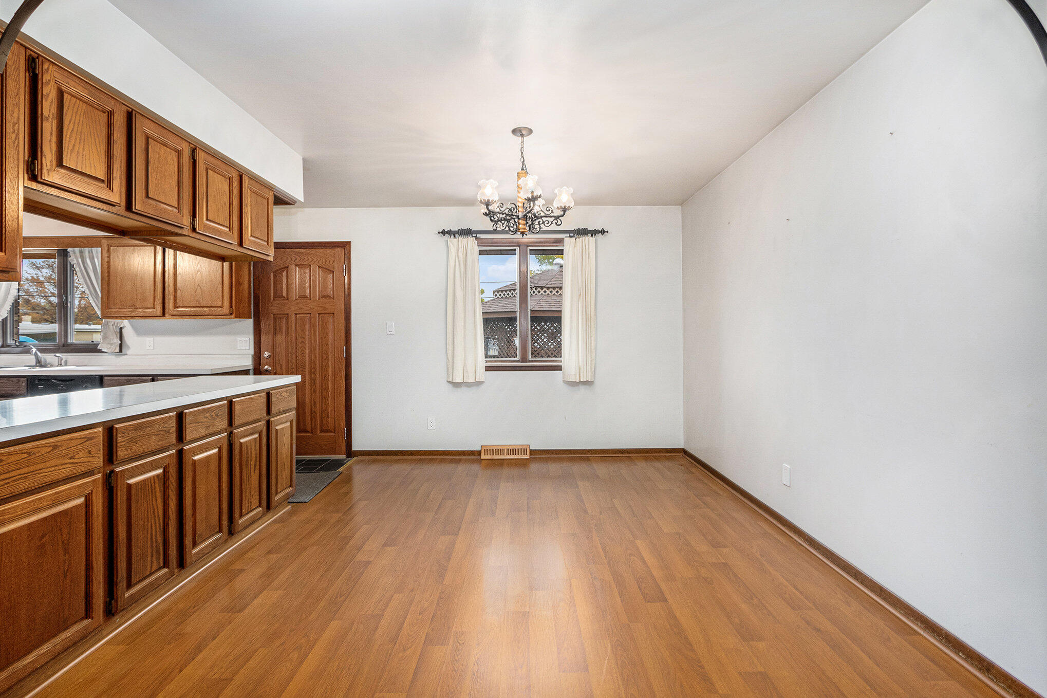 7905 Frederick Avenue Munster, IN 46321 - Photo 6 of 26 a view of a kitchen with granite countertop cabinets stainless steel appliances and a window