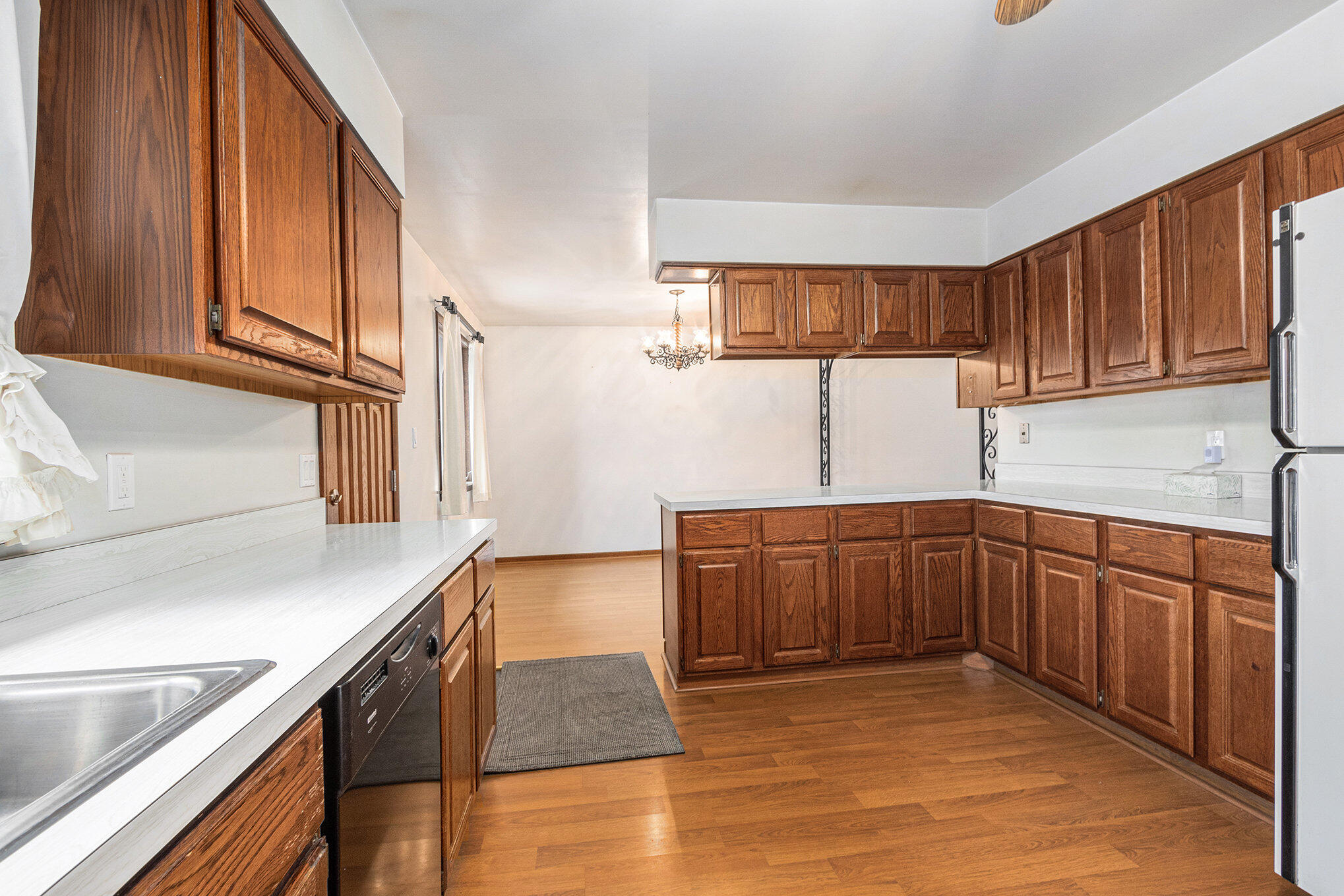 7905 Frederick Avenue Munster, IN 46321 - Photo 7 of 26 a kitchen with stainless steel appliances granite countertop a sink dishwasher stove and cabinets with wooden floor