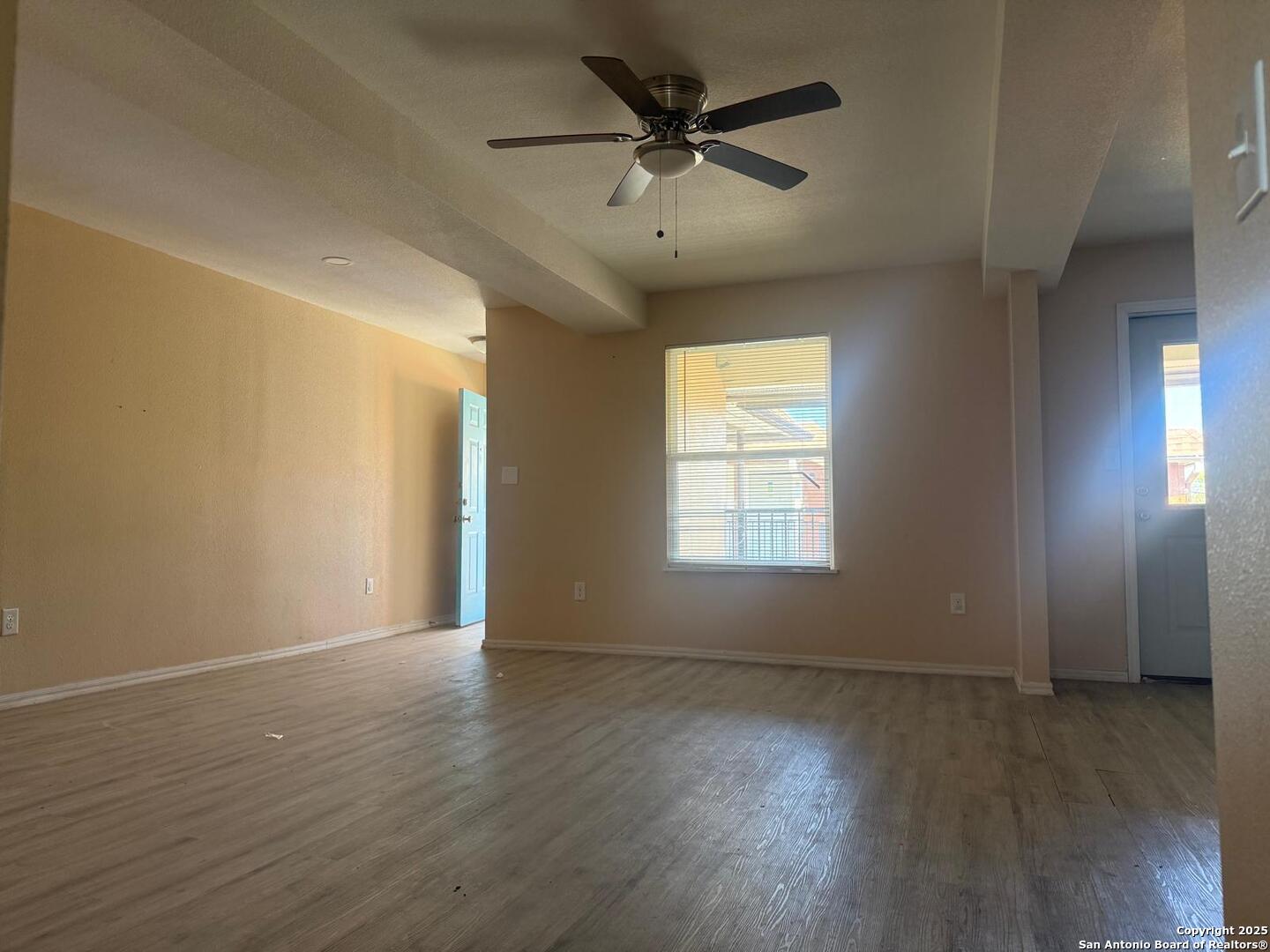 3718 Pleasanton Road, Unit 2201 San Antonio, TX 78221 - Photo 4 of 7 an empty room with wooden floor and windows