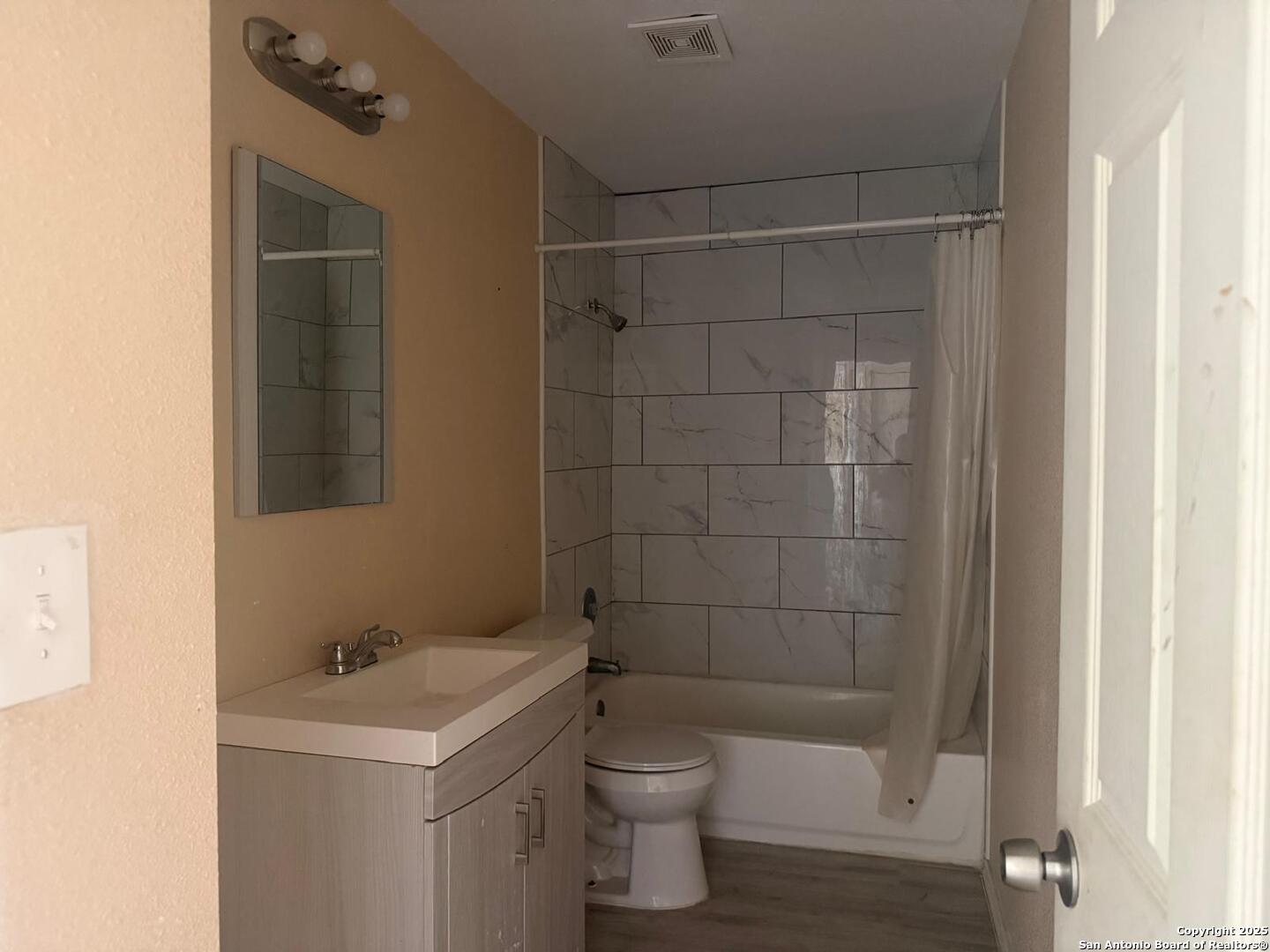 3718 Pleasanton Road, Unit 2201 San Antonio, TX 78221 - Photo 6 of 7 a bathroom with a sink a toilet and shower