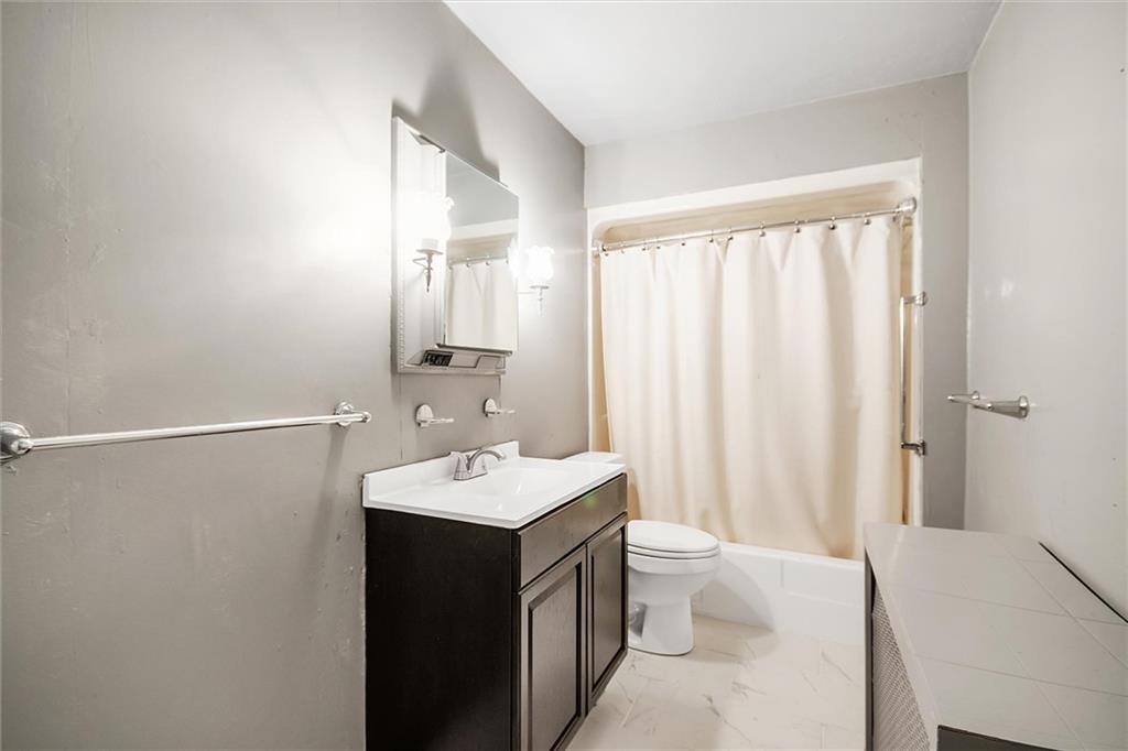 2133 Brighton Road Pittsburgh, PA 15212 - Photo 19 of 23 a bathroom with a double vanity sink toilet and a mirror