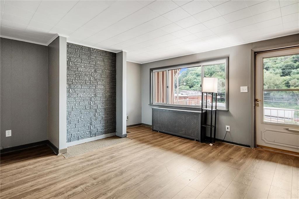 2133 Brighton Road Pittsburgh, PA 15212 - Photo 6 of 23 a view of an empty room with a window and wooden floor