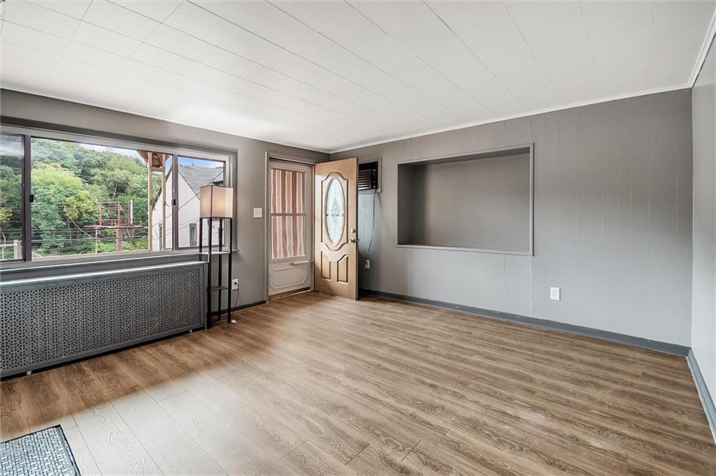 2133 Brighton Road Pittsburgh, PA 15212 - Photo 7 of 23 an empty room with wooden floor and windows