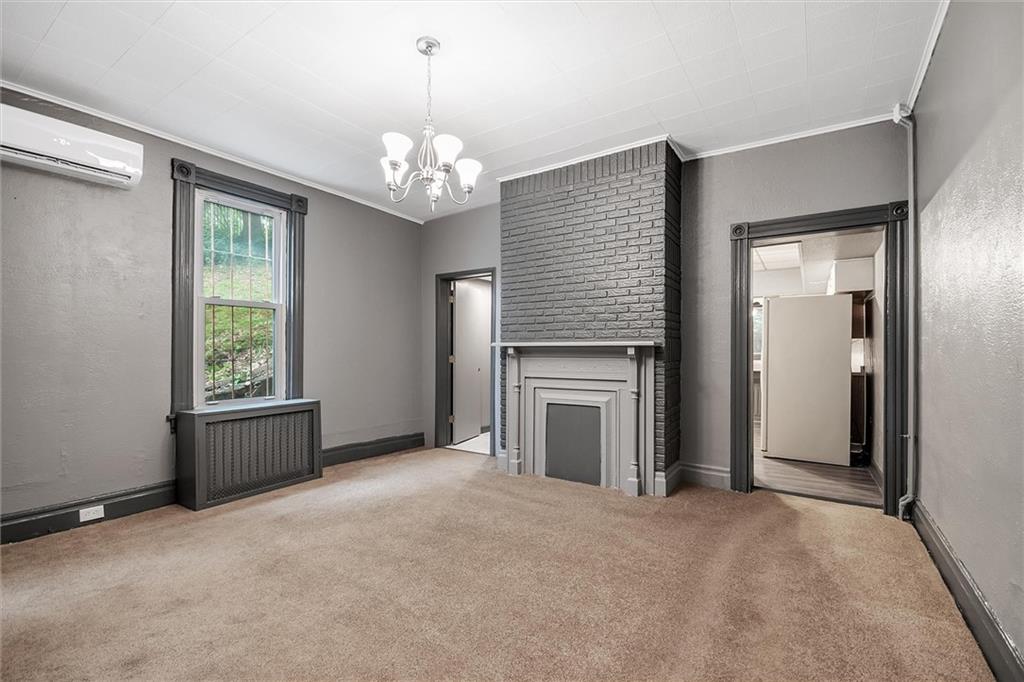 2133 Brighton Road Pittsburgh, PA 15212 - Photo 8 of 23 an empty room with windows and fireplace