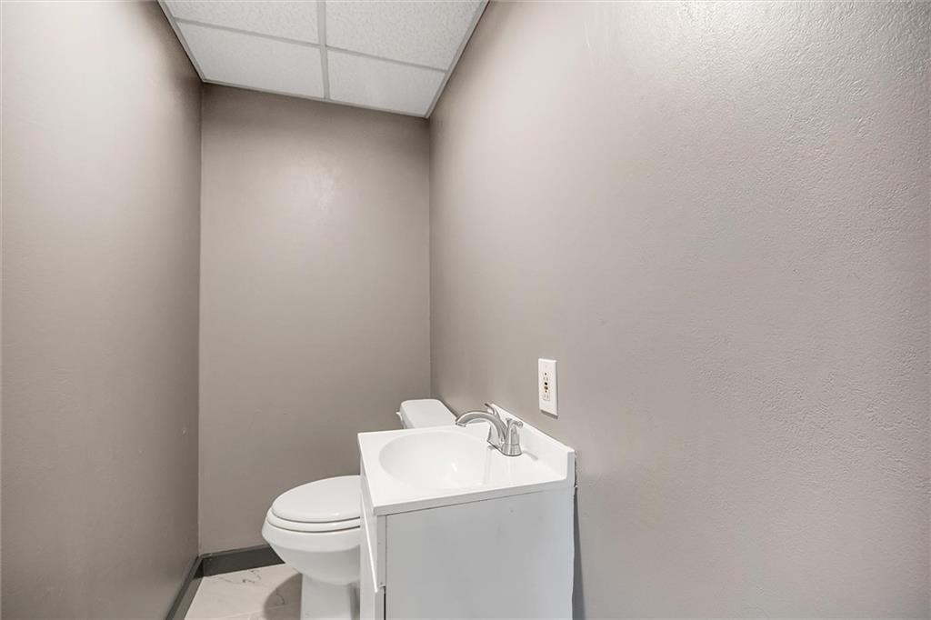 2133 Brighton Road Pittsburgh, PA 15212 - Photo 10 of 23 a bathroom with a toilet sink and mirror