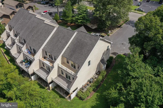 an aerial view of residential house with outdoor space and trees all around