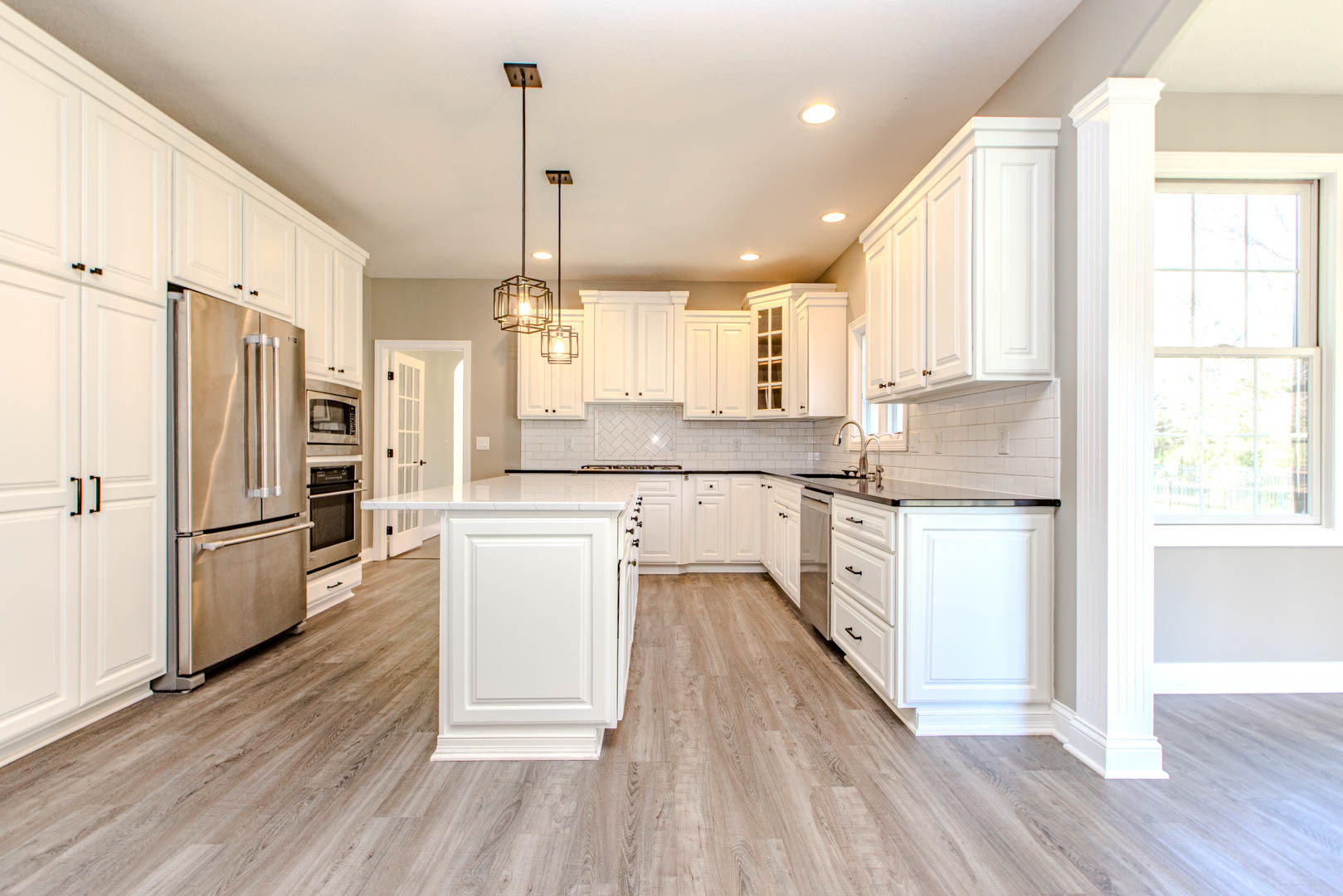 59 Stonebrook Court Bloomington, IL 61704 - Photo 12 of 52 a kitchen with a refrigerator a sink and wooden floor