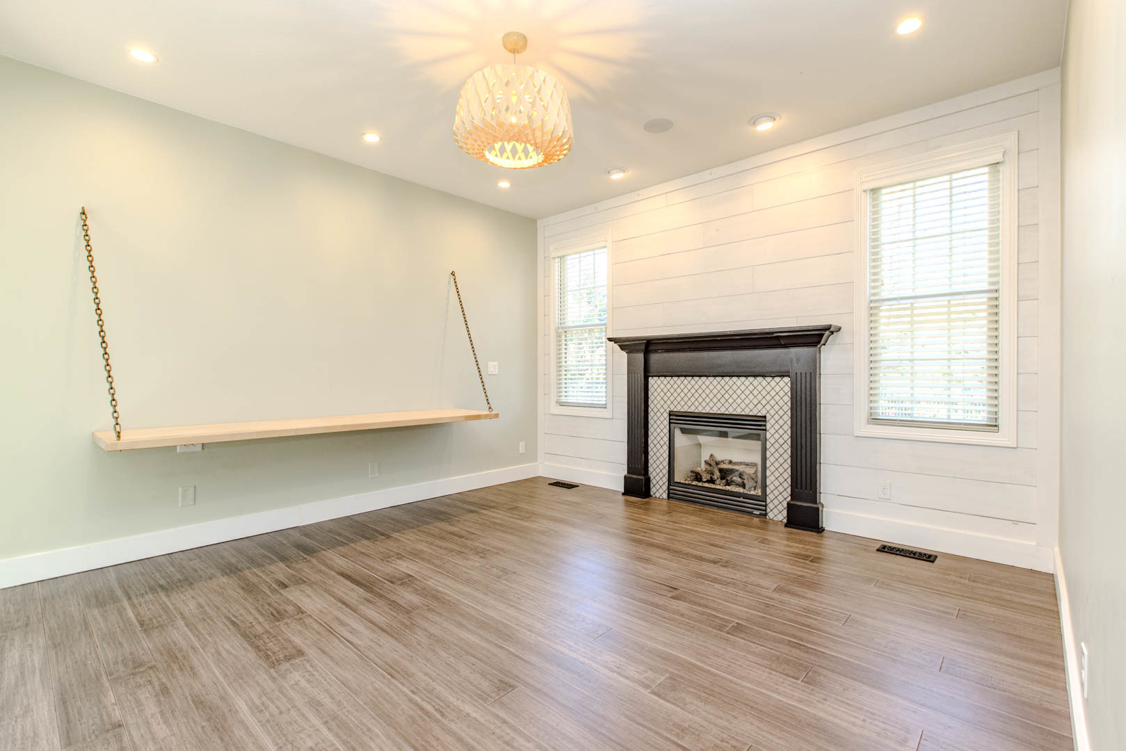 59 Stonebrook Court Bloomington, IL 61704 - Photo 18 of 52 an empty room with wooden floor fireplace and windows