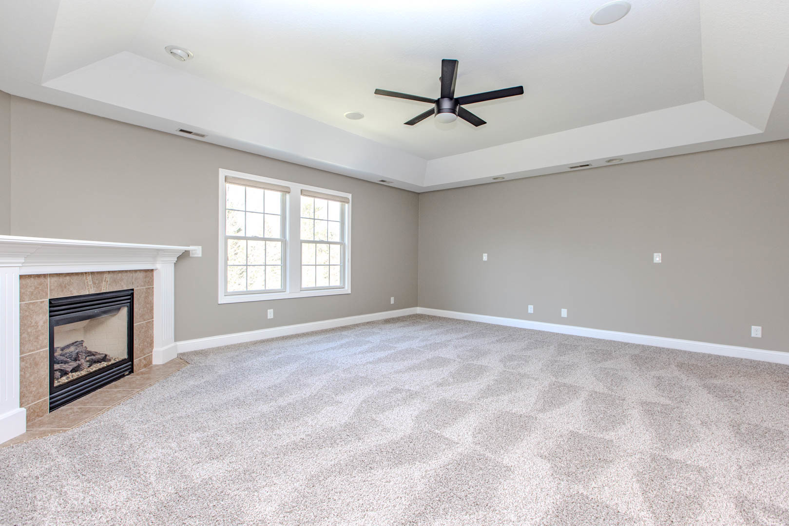 59 Stonebrook Court Bloomington, IL 61704 - Photo 22 of 52 a view of an empty room with a fireplace and a window