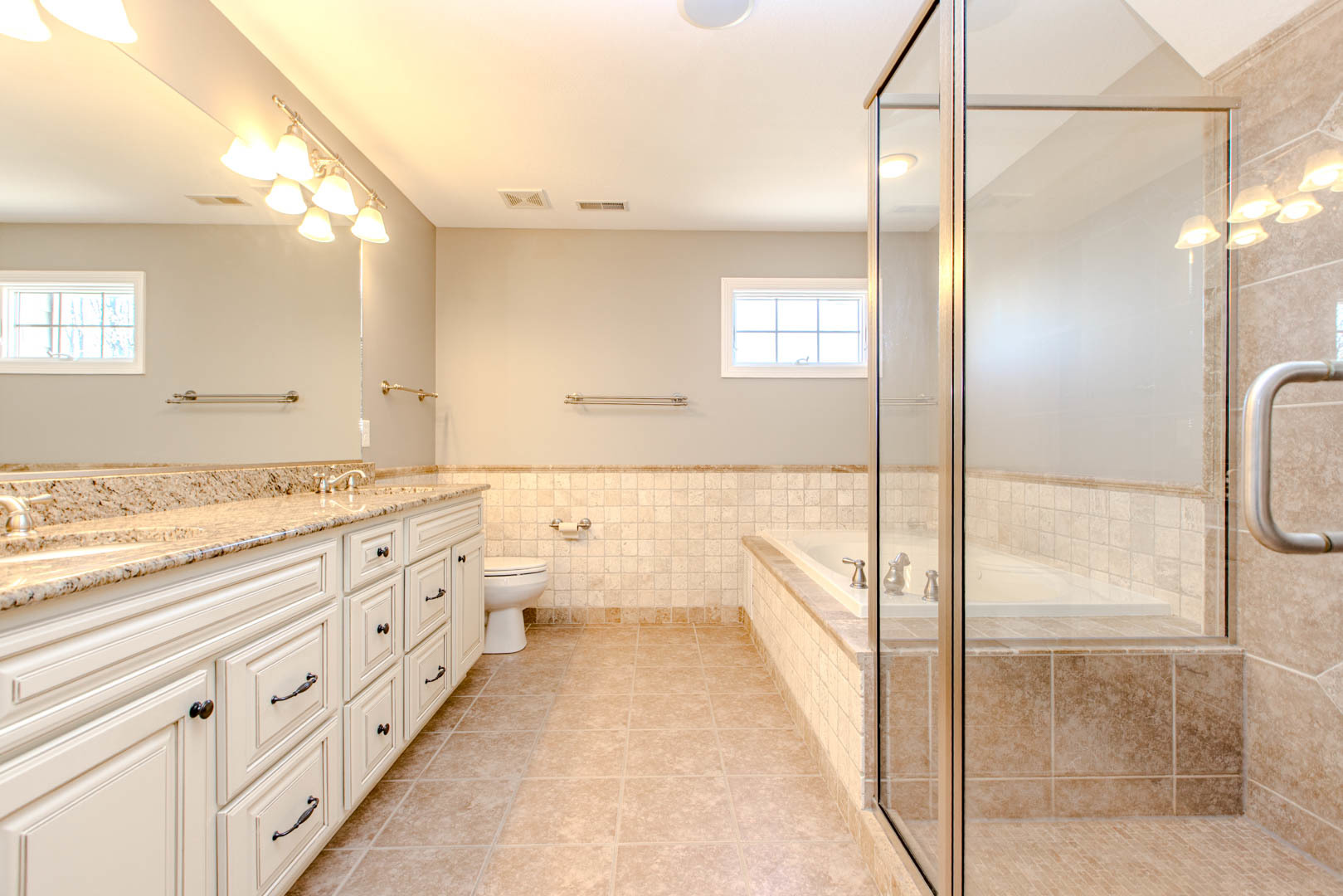 59 Stonebrook Court Bloomington, IL 61704 - Photo 25 of 52 a bathroom with a granite countertop sink mirror and a bathtub