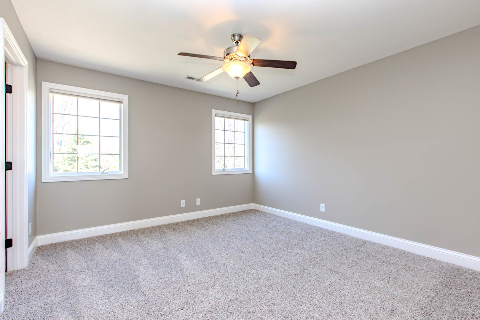 59 Stonebrook Court Bloomington, IL 61704 - Photo 29 of 52 an empty room with windows and chandelier fan