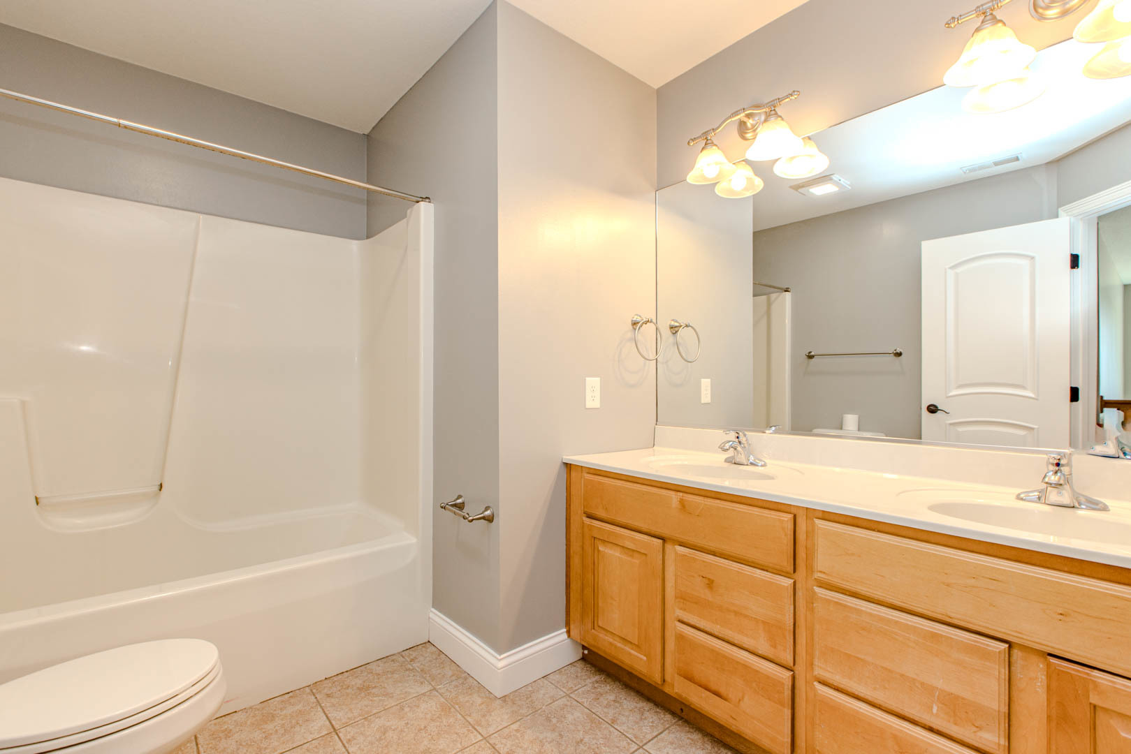 59 Stonebrook Court Bloomington, IL 61704 - Photo 32 of 52 a bathroom with a sink a toilet and a large mirror