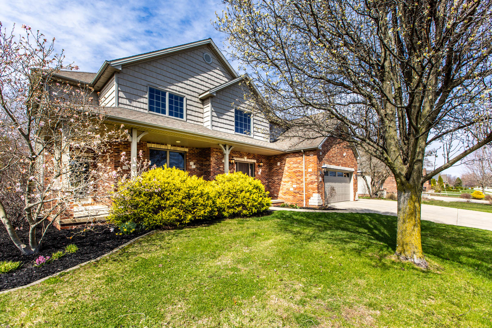 59 Stonebrook Court Bloomington, IL 61704 - Photo 52 of 52 a front view of a house with a garden and trees