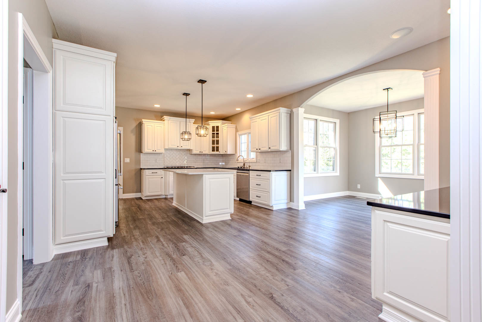 59 Stonebrook Court Bloomington, IL 61704 - Photo 10 of 52 a view of a kitchen with a fridge and wooden floor