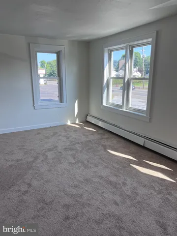 an empty room with windows and closet