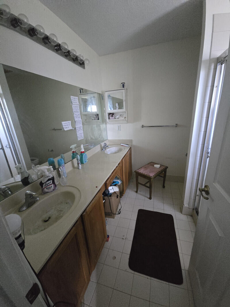 6511 Sandy Bank Terrace Riviera Beach, FL 33407 - Photo 7 of 12 a bathroom with a sink double vanity and a mirror