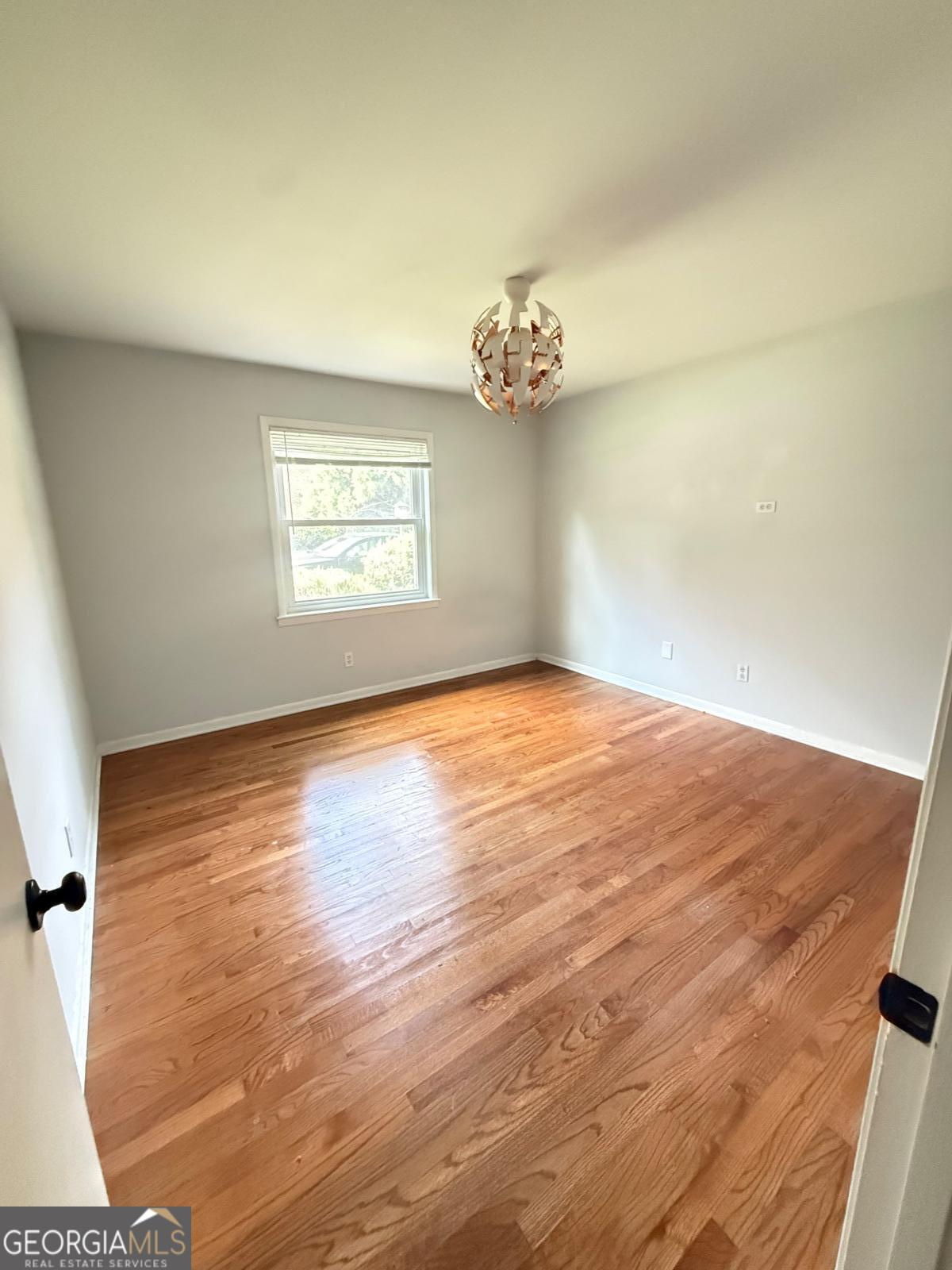 3510 Roswell Road, Unit H1 Atlanta, GA 30326 - Photo 15 of 43 an empty room with wooden floor and windows