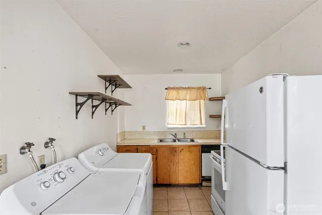 a room with a window and a refrigerator