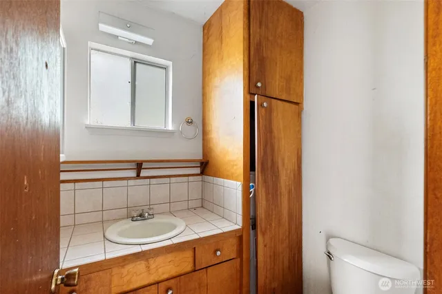 a bathroom with a granite countertop sink and mirror