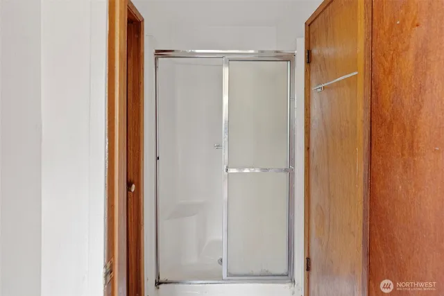 a view of walk in closet with empty room
