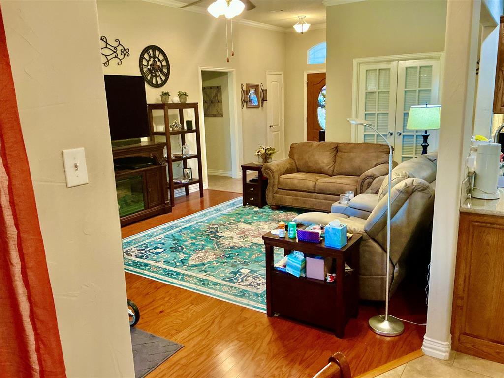 312 McAfee Street Mabank, TX 75147 - Photo 27 of 40 a living room with furniture and a flat screen tv